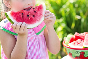 Child eating watermelon at daycare