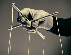 Hand manipulating puppet strings